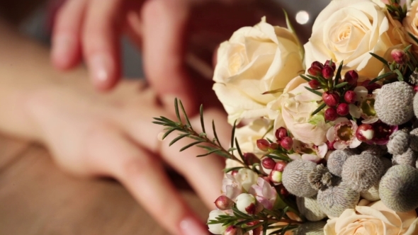 Hands Next To Wedding Bouquet