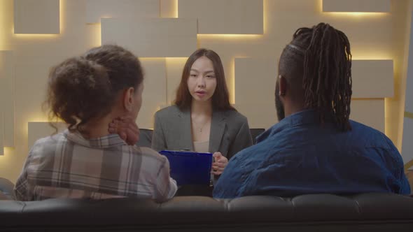 Pretty Asian Female Psychologist Counselling Multiracial Couple During Therapy alt