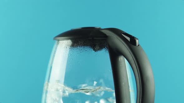 An Electric Kettle with Transparent Walls. Boiling Water. Bubbles. Close-up alt