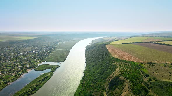Aerial drone view of nature in Moldova. Village located near a valley with river alt