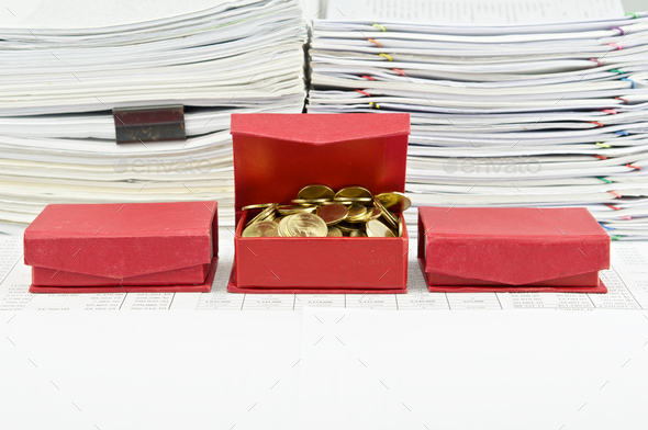 Gold coins in open red box arrange on finance account