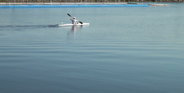A Man Swims on a Kayak