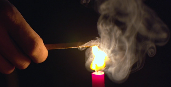 Lighting of match with candle fire