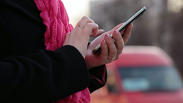 Girl on Street Use Mobile Phone alt