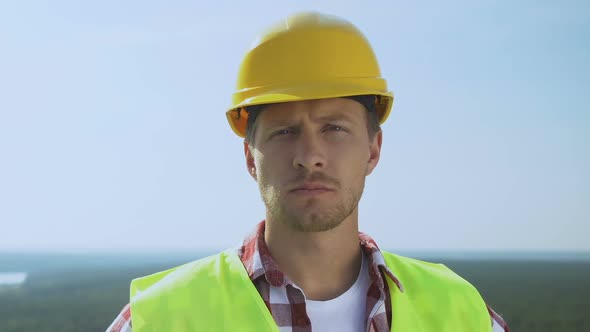 Experienced Male Builder in Safety Helmet Looking at Camera, Qualitative Service