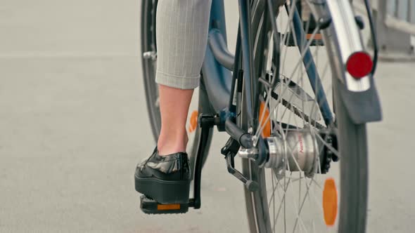 Background Close Up of Bicycle Wheels and Female Feet Cycling with Copy Space