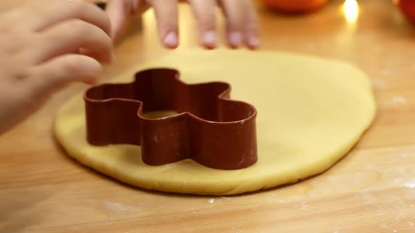 Christmas sweets, a child makes gingerbread with his hands.