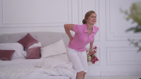 Woman Felt Back Pain Getting Out of Bed alt