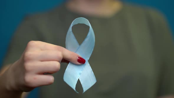 World Diabetes Day. Blue Ribbon Symbolic Isolated with Hand Support