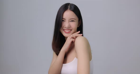 Beauty Shot Of Beautiful Asian Girl Looking At Camera On Grey Background. alt