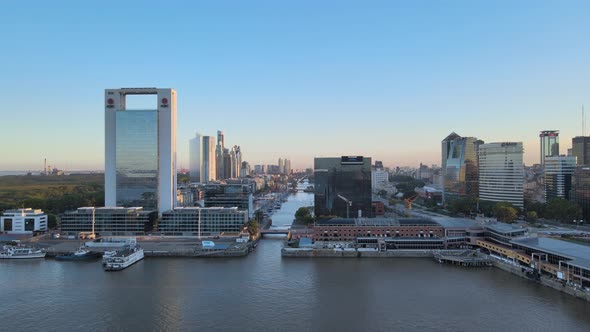 Aerial dolly in from north dock of Puerto Madero toward the waterfront high rise buildings and strai alt