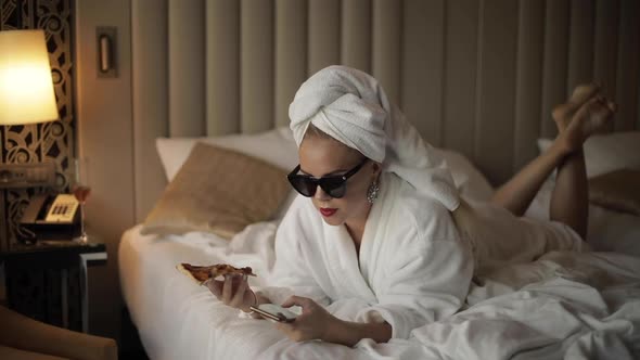 Stylish Girl in Bathrobe and Towel Chatting with Pizza in Hand