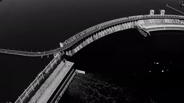 Fly Over the Weir and Power Lines of Water-power Plant. High Contrast Noir Black and White Footage alt