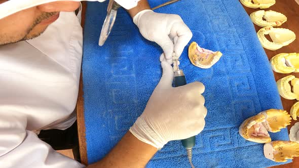 Dental Technician Polishing A Tooth