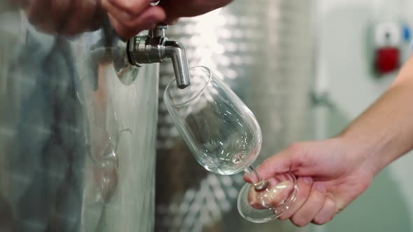 Crop Man Pouring New Wine From Barrel alt