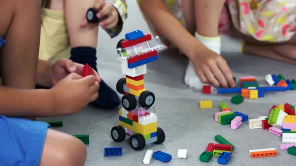 Close Up Kids Playing with Block Toys in Nursery School alt