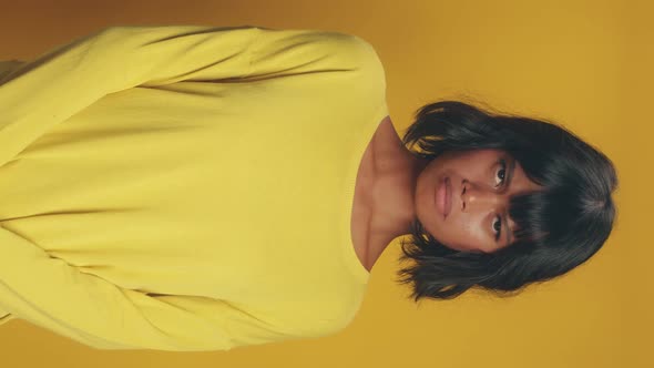 Vertical View Young Ethnic Asian Woman Looking at Camera and Pursed Lips alt