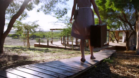 Senior woman standing with her arms wide open in resort 4k alt