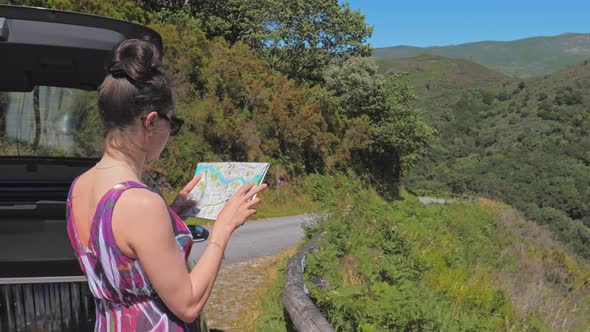 Woman Travels By Car, Map in Her Hands