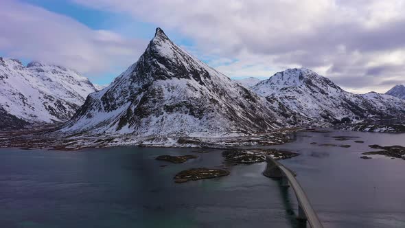 Fredvang Bridge and Volandstind Mountain in Winter. Lofoten, Norway. Aerial View alt