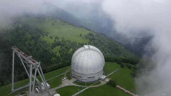 Aerial view of Astrophysical observatory, BTA tower. Flowing clouds. Astronomy. Nizhny Arkhyz Russia