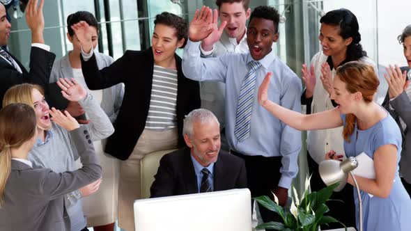 Business people giving a high five to each other alt