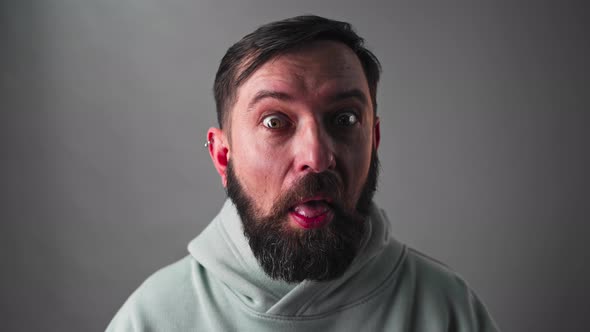 Portrait of Funny Bearded Surprised Man Looking at Camera  Shot in Slow Motion