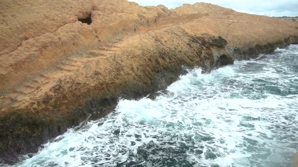 The Waves Beat Against the Rocks. Storm on the Mediterranean Sea. The Sea Is Turquoise. Slow Motion. alt