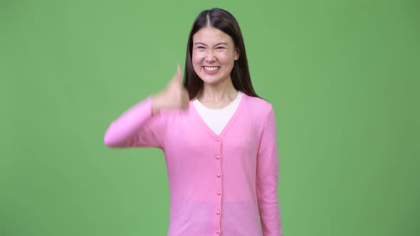 Young Beautiful Asian Woman Giving Thumbs Up