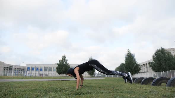 Sporty Girl Working Out on Grass Crossfit Strength Training at the Stadium alt