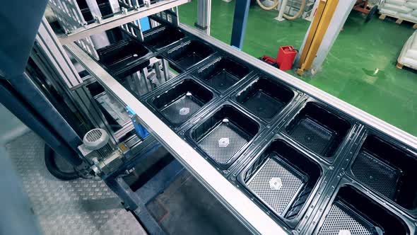Plastic Containers Are Getting Transported By the Conveyor alt