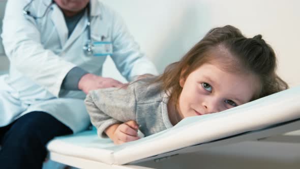 Doctor inspecting child's back