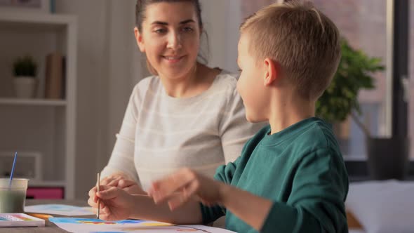 Mother and Son Drawing and Making High Five alt