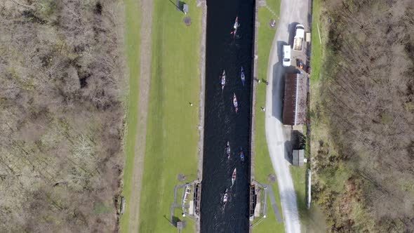 A Large Group of Canoeists Traversing a Canal Lock alt