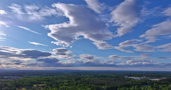 Fluffy Cumulus Clouds Move Slowly Low Over the Horizon a Small American Town Near Forest alt