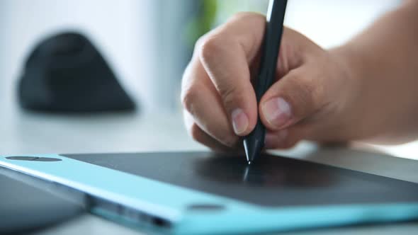 Graphic Designer Hands Using Digital Graphic Tablet in Office.