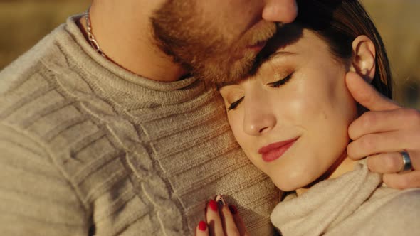 Guy hugs girl on his chest alt