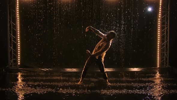 Young Man Sexy Dancing in Rain in Unbuttoned White Shirt alt