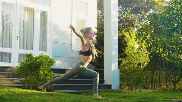 Sporty Woman Is Doing Yoga Practice Exercise on the Backyard of Her House.