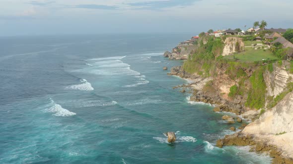 Aerial View of Beautiful Ocean Waves Splashing Towards a Beautiful Rocky alt