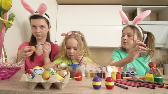 Girls at Home in the Kitchen Paint Easter Eggs with Paint