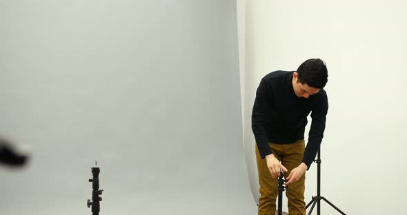 Male photographer working in the studio alt