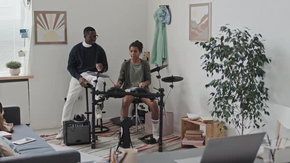 Man Teaching Tween Play Drums alt