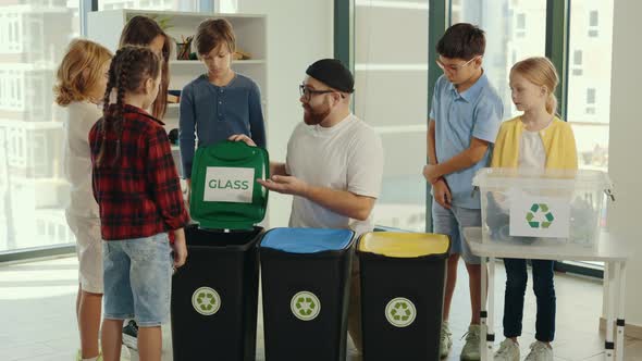 Garbage Sorting Lesson a Young Male Teacher Tells and Explains to Children How and Where to Sort alt