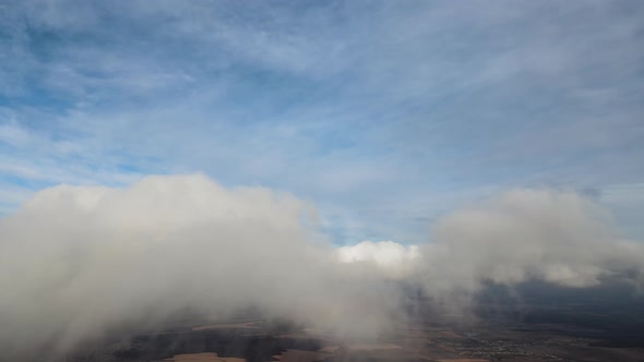 Aerial View From High Altitude of Earth Covered with Puffy Rainy Clouds Forming Before Rainstorm alt