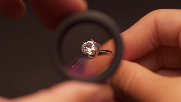 Appraiser Examines Ring Through Loupe
