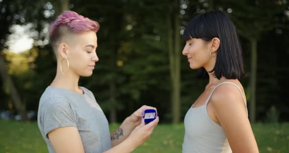 Pretty Lesbian Woman Proposing to Her Girlfriend to Get Married and Smiling alt