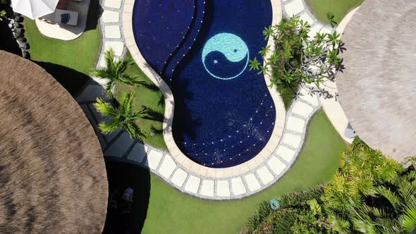 Aerial zoom out directly above Impiana Private Villas resort in Seminyak, Bali alt
