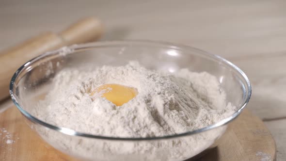 Egg Falls on a Pile of Flour. Shot with High Speed Camera. Slow Motion alt