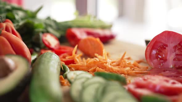 Closeup Salad Ingredients with Grated Carrot Falling in Slow Motion alt